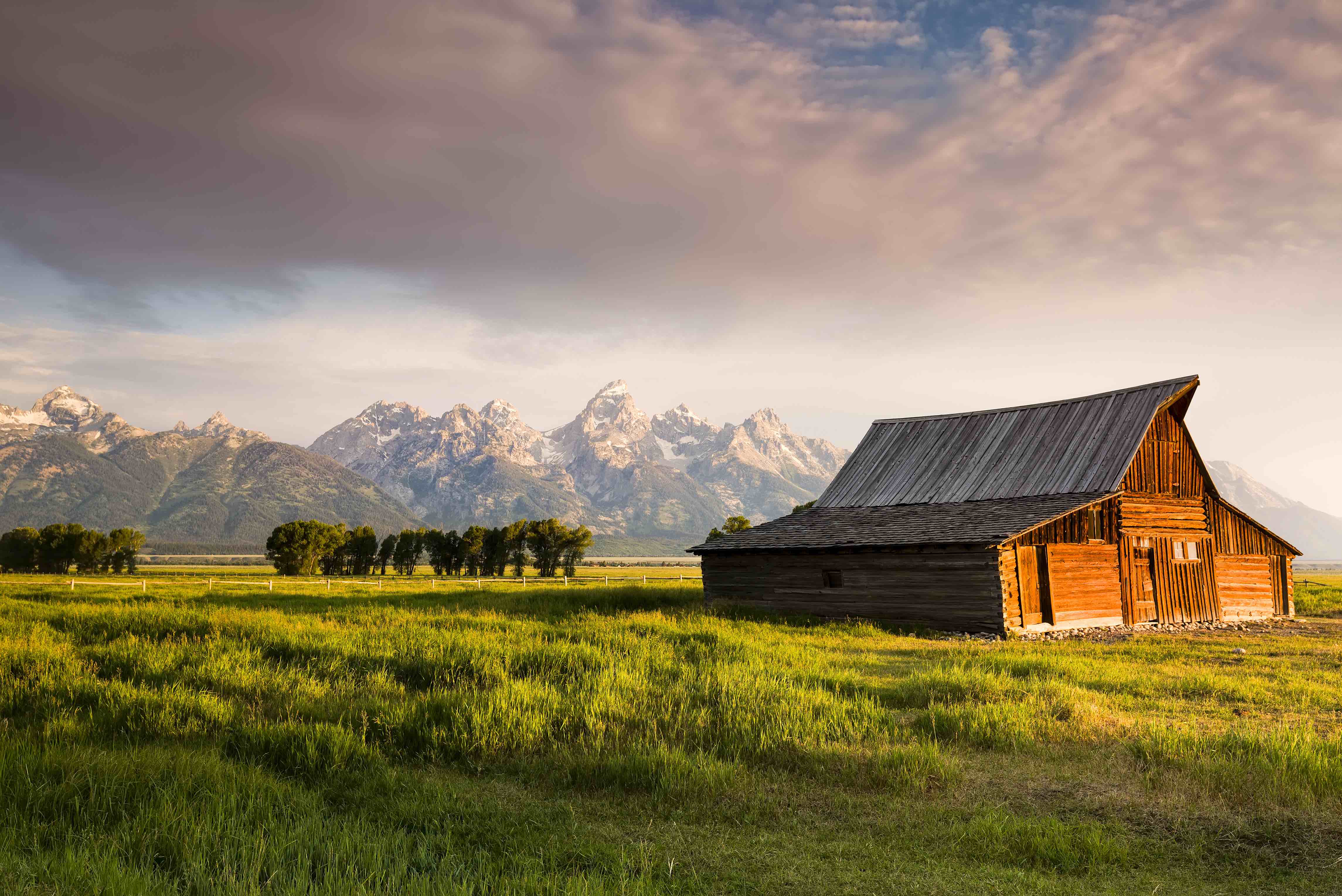 Iconic T. A. Moulton barn and Teton peaks at dawn in Grand Teton National Park, WY
